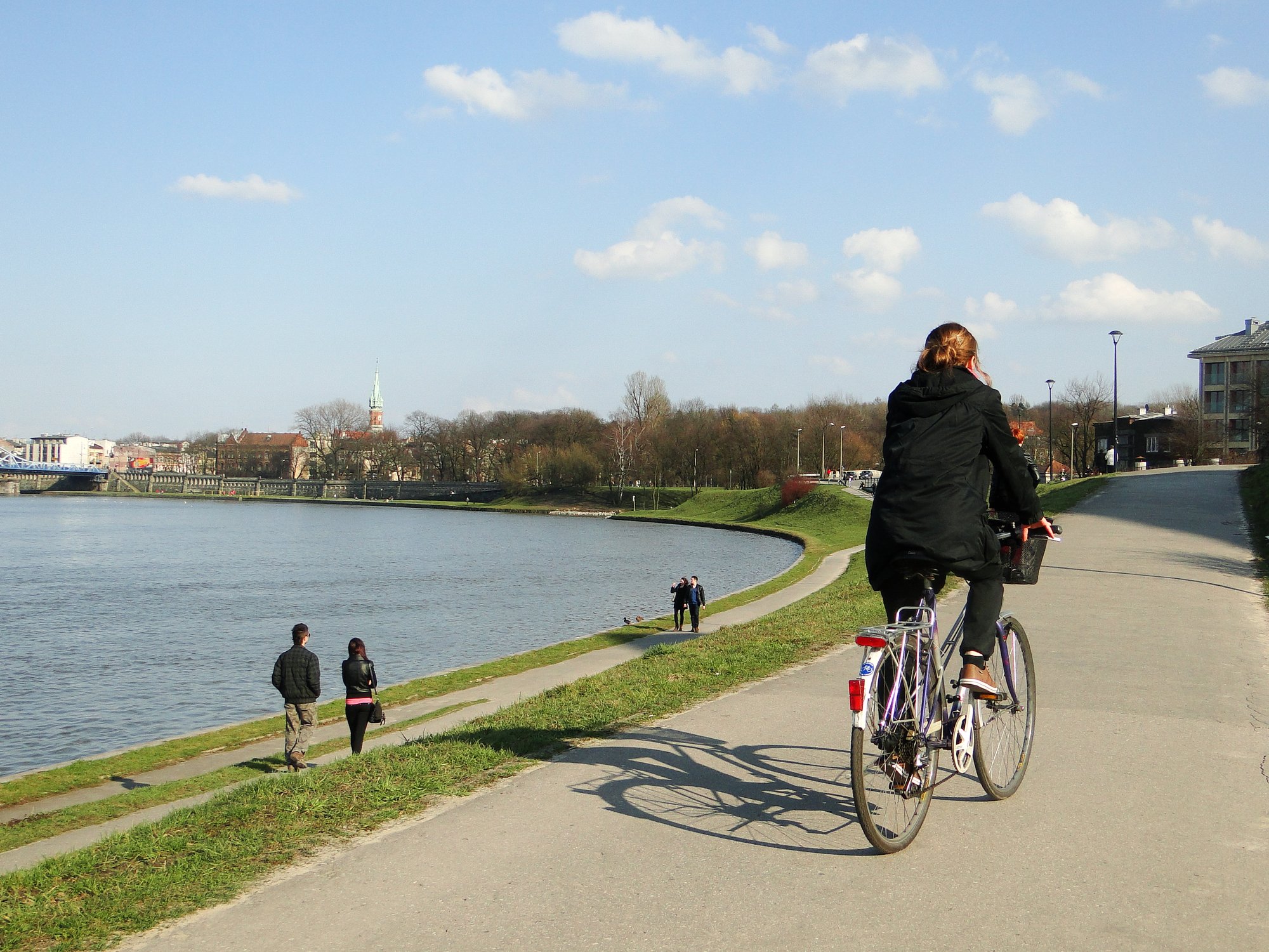 A lone cyclist on the Vistula boulevard in Krakow